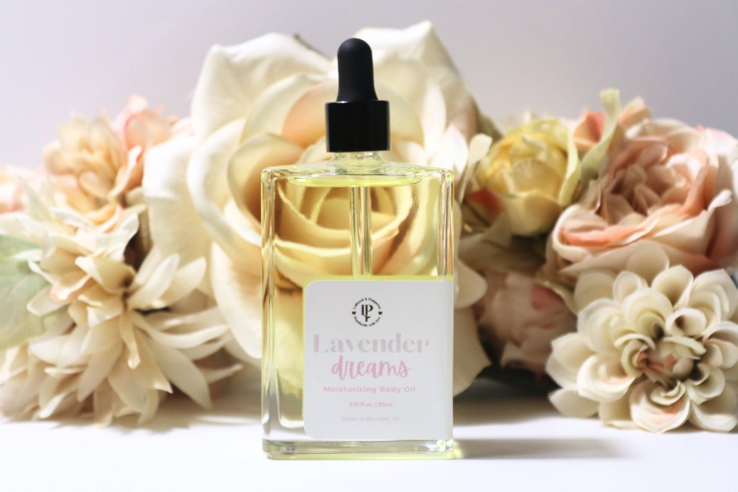 Clear bottle of Lavender Dreams body oil with scent notes of lavender, coconut water and eucalyptus