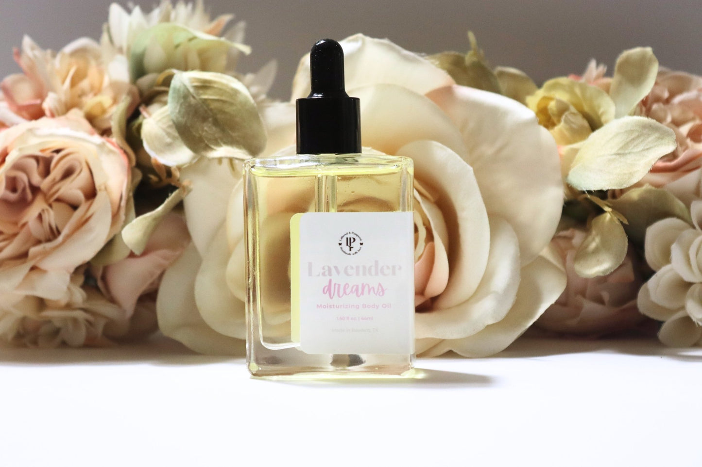 Clear bottle of Lavender Dreams body oil with scent notes of lavender, coconut water and eucalyptus