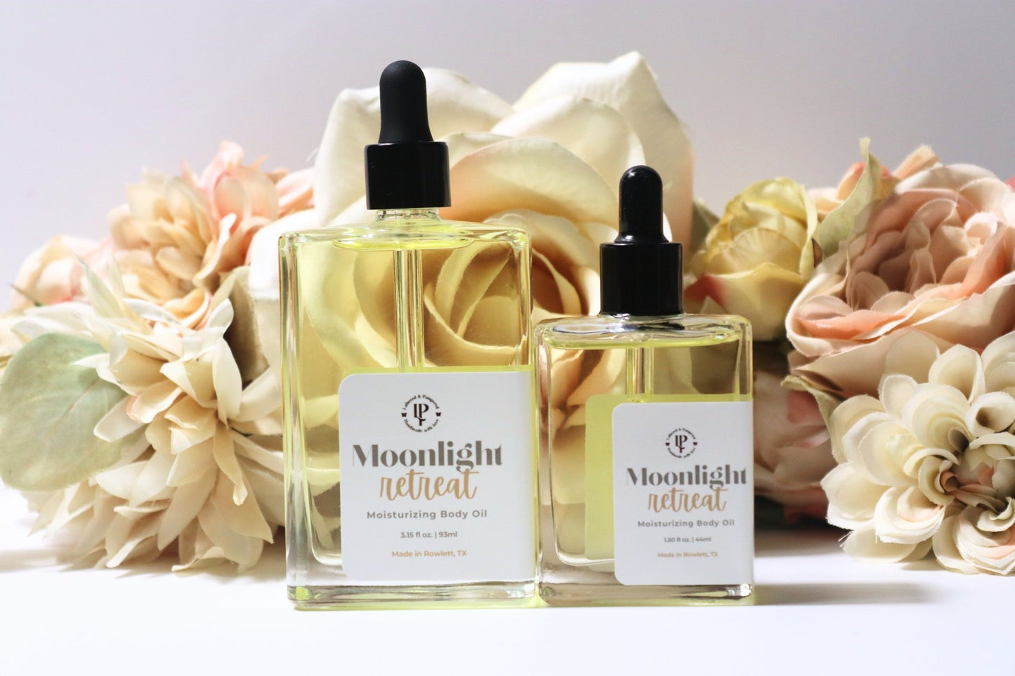 Moonlight Retreat body oil in a clear bottle, with scent notes of Star Anise, Balsamic Reduction & Sweet Vanilla.