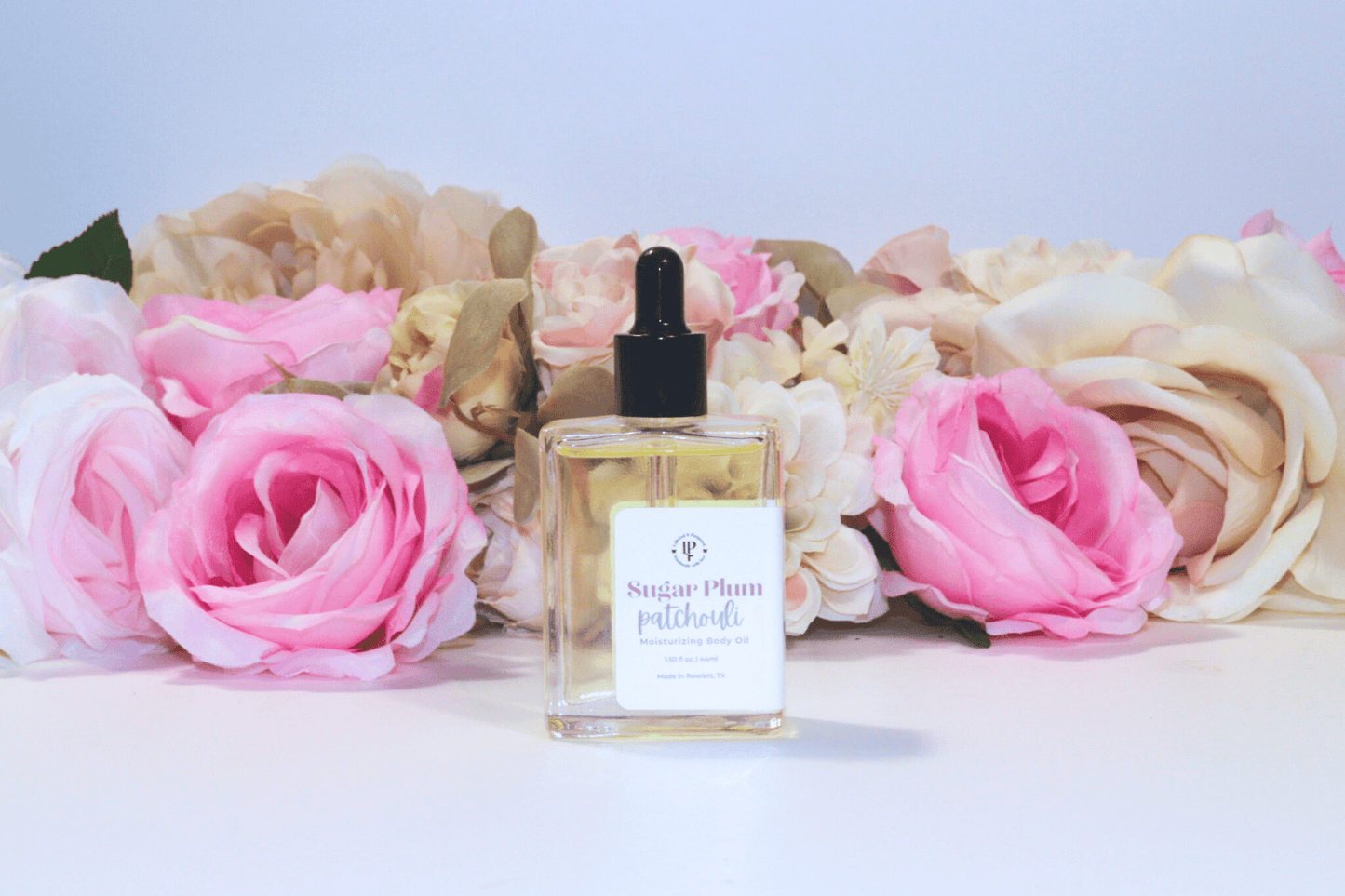 Sugar Plum Patchouli body oil in a clear glass bottle with scent notes of Ripe Plums, Wild Berries, Patchouli and Sandalwood