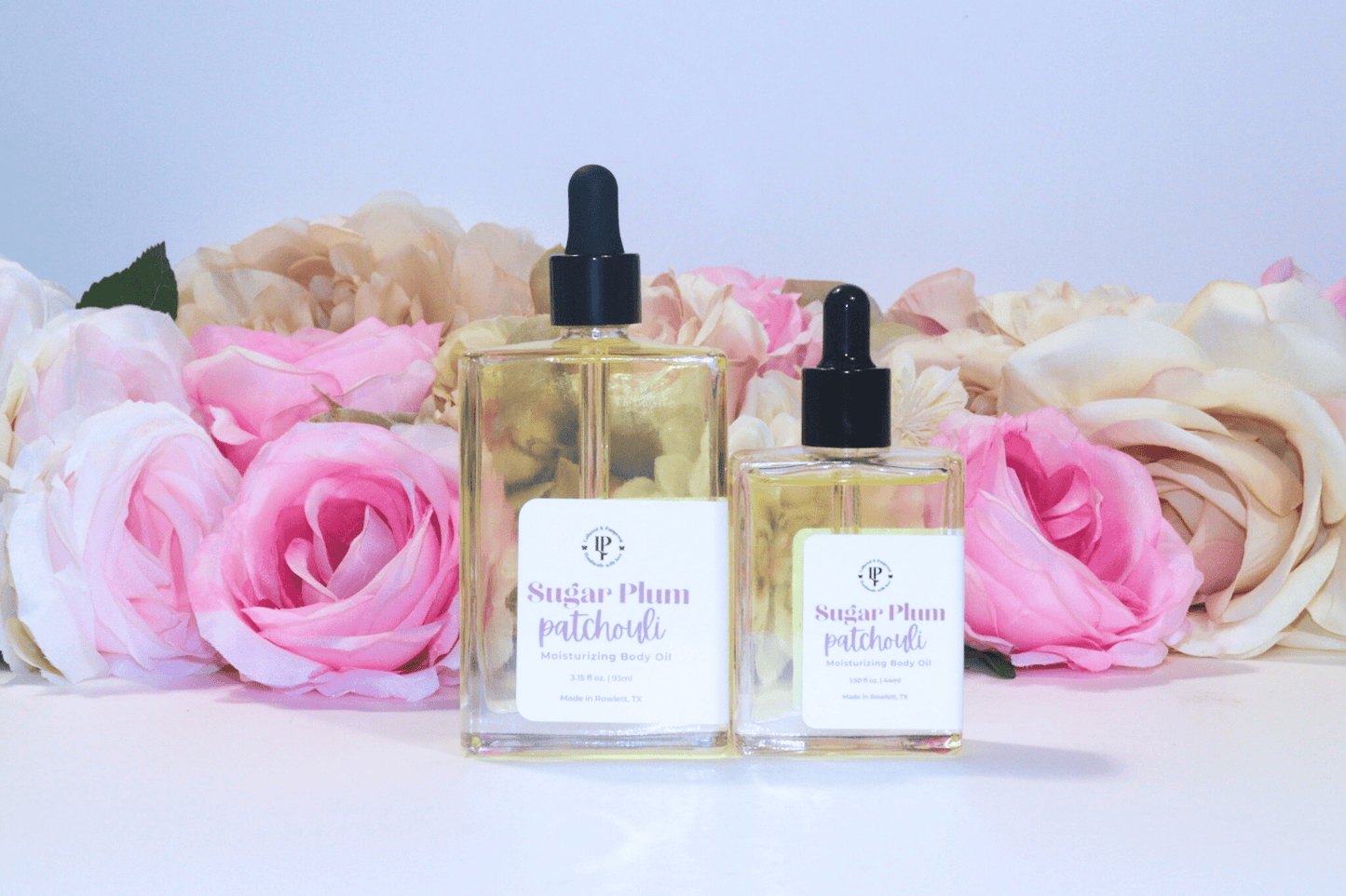 Sugar Plum Patchouli body oil in a clear glass bottle with scent notes of Ripe Plums, Wild Berries, Patchouli and Sandalwood
